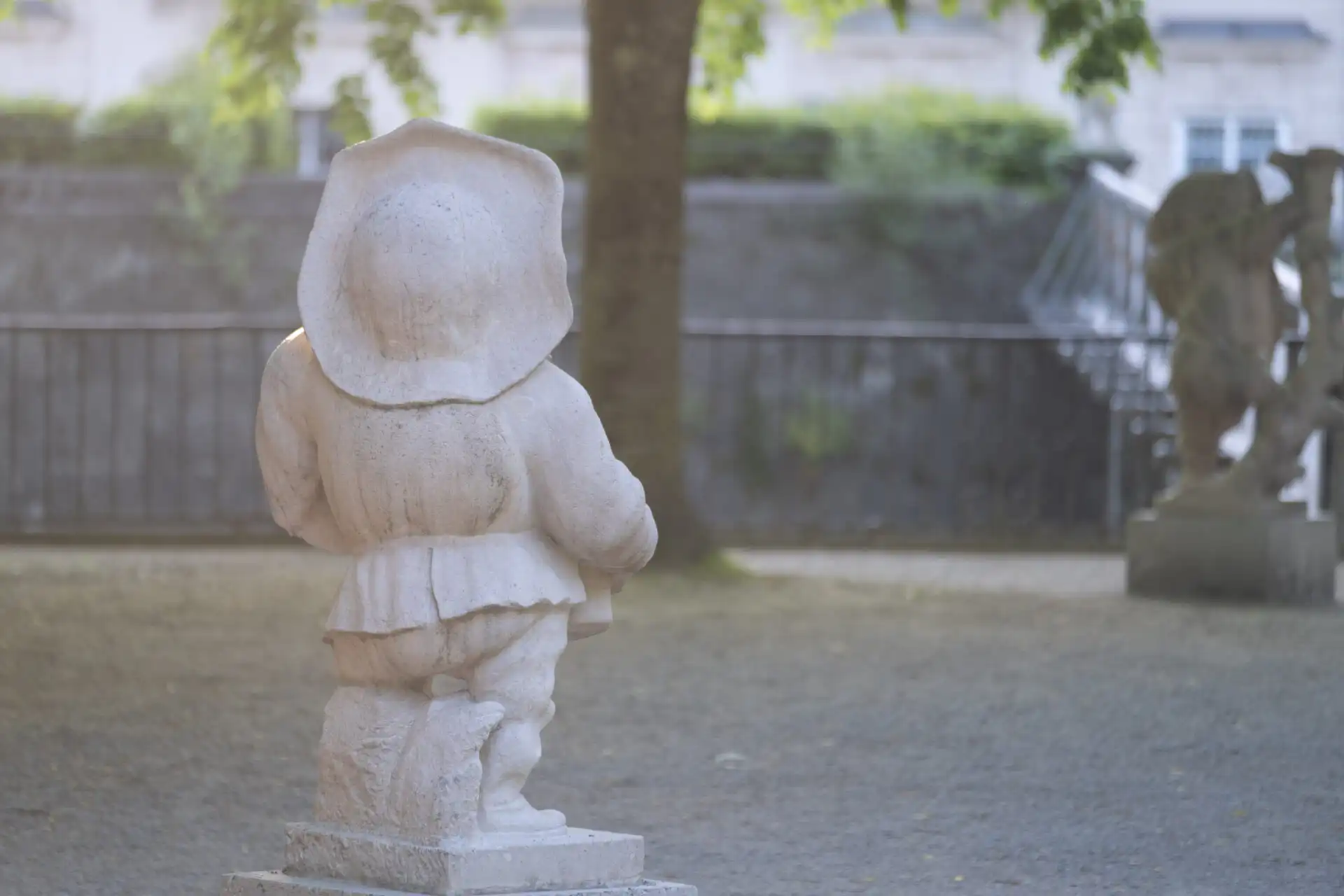 Marble dwarf statue in the Zwerglgarten at Mirabell